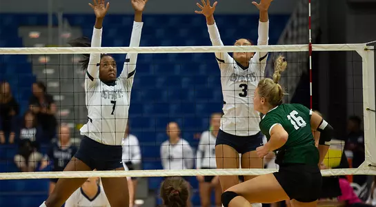 Devyn Wheeler and Gabby O'Connell jumping at the net to block a Stetson attack.