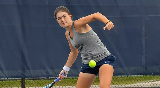 Constanza Gorches returns a low tennis ball at the tennis court.