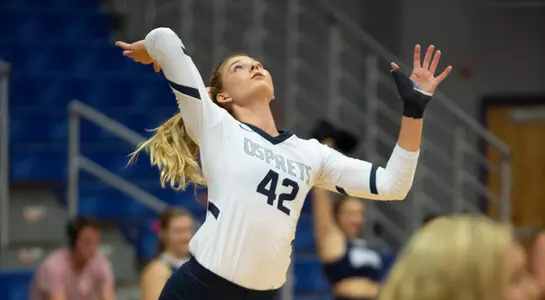 Taryn Griffey looks above her during the process of making a service attempt.