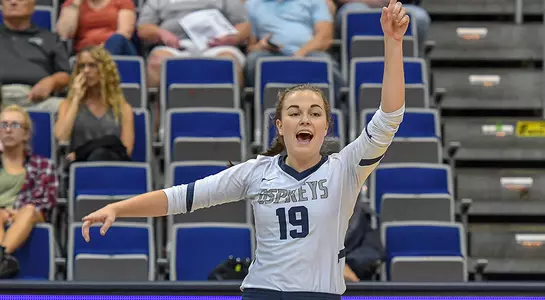 Kaileen Herman signals to her teammates during a volleyball match.