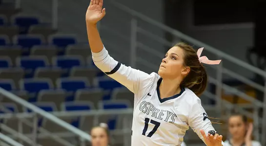 Madilyn McCarty follows through after hitting the volleyball on her serve.