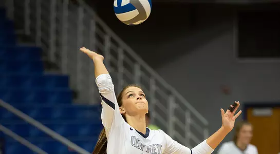Madilyn McCarty looks at the volleyball in preparation for her serve.