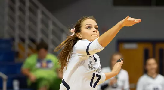 Madilyn McCarty follows through upon hitting the ball during a serve.