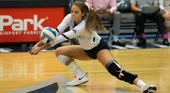 Madilyn McCarty digs the volleyball.