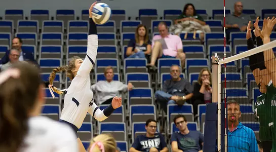 Kirby Smith reaches high to connect with the volleyball.
