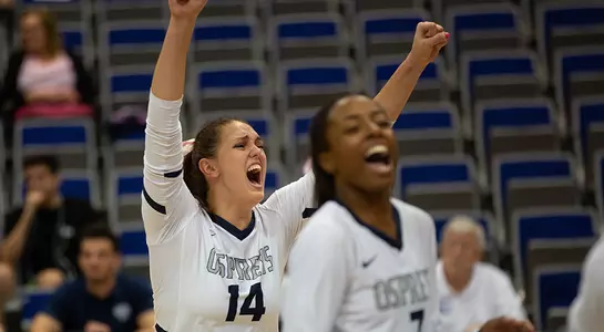 Alana Shoff and Devyn Wheeler celebrate a point during a UNF Volleyball match.