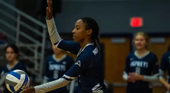 Devyn Wheeler prepares to serve the ball during a volleyball match.
