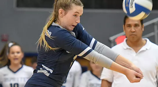 Callie Workman reaches to dig a ball during the volleyball match.