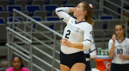Callie Workman rears back to hit the volleyball during her serve.