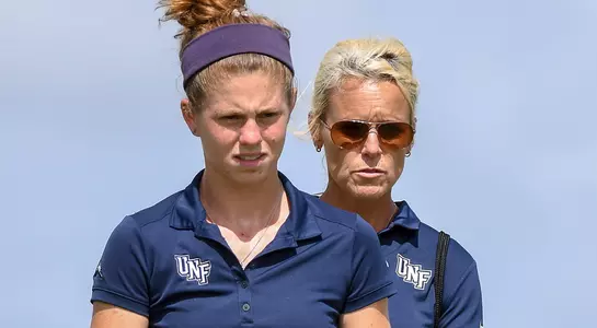Sydney Shrader and Joanne Berglund discussing a putting line