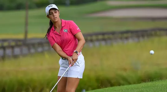 Mindy Herrick chips a ball from the fringe of the green