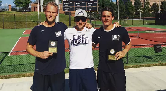 Picture of Barton and Von Winning with head coach Matt Lucas on the tennis courts of Mercer University.