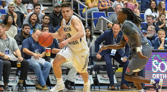 Ivan Gandia-Rosa drives to the basket against Edward Waters at UNF Arena.