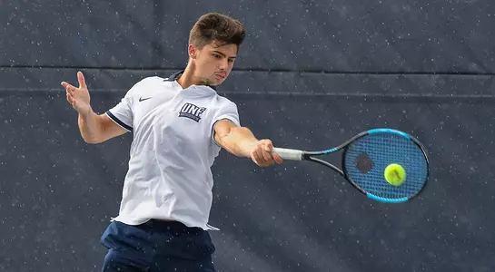Joe Ellis returns the tennis balls with his forehand.