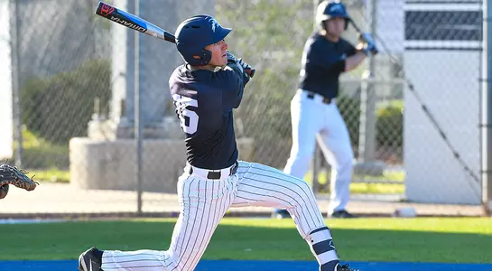 Alex Hendricks holds his follow-through after taking a swing at the ball