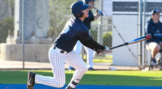 Alex Hendricks hold his follow-through, watching the ball he just hit