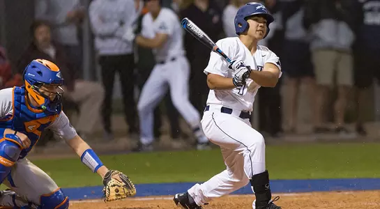 Raff Libunao hits the baseball towards first base
