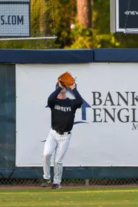 Chris Matthias opens his glove to catch a ball in the outfield