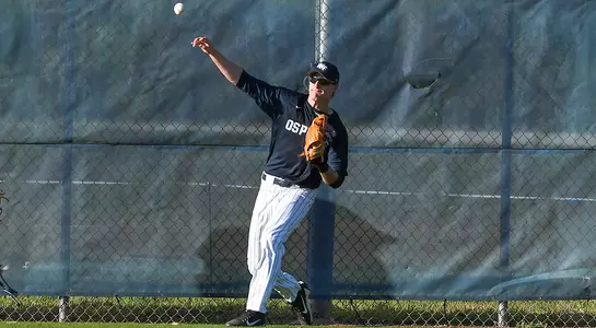 Tanner Murphy throws the ball towards the infield from the fence