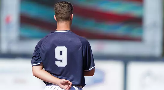 Alex Reynolds stands with his hand on his heart during the national anthem