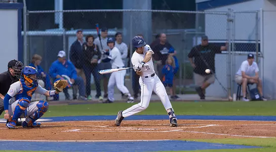 Wes Weeks takes a swing of his bat at an incoming pitch