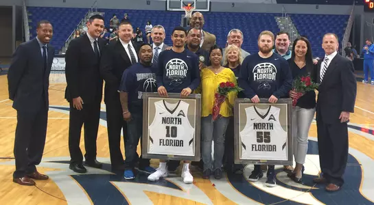 Basketball seniors Osborn Blount and Chase Driscoll pose with their families before their final home game