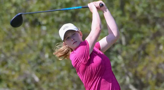 Teresa Conroy follows through on a tee shot