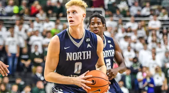 Noah Horchler holds the ball on his hip in preparation of making a drive to the basket