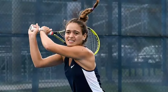 Sophomore Lucia Montano returns the tennis ball.