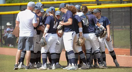 Softball team huddles after the game.