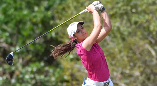 Mindy Herrick follows through on a shot from the fairway