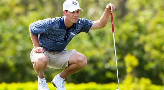 Philip Knowles squats to line up a putt