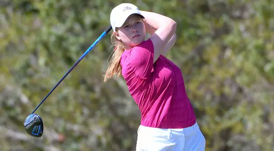 Teresa Conroy follows through and stairs down her tee shot