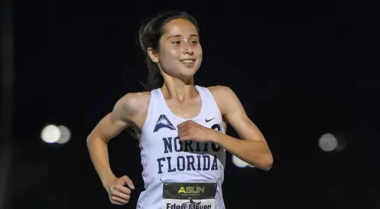 Eden Meyer  smiles as she crosses finish line to win the 10,000 meter championship