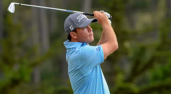 Andrew Alligood watches the flight of his golf ball after hitting at shot at the US Amateur