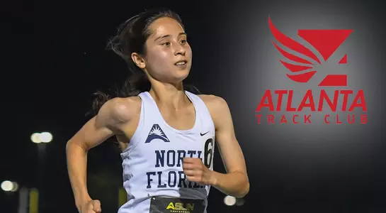 Eden Meyer crosses the finish line alongside an image of the logo for the Atlanta Track Club
