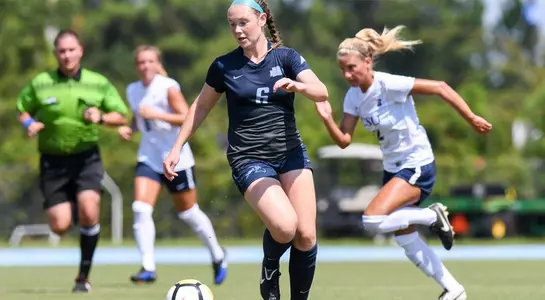 Brandi Walker dribbles a soccer ball in a game