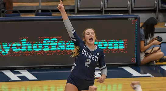 Sophomore defensive specialist celebrates by pointing into the sky after winning a point.