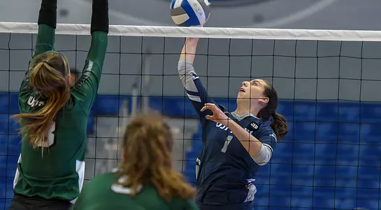 Solimar Cestero makes an attack attempt on the ball at the net, avoiding a USC Upstate blocker