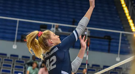 Number 42 Taryn Griffey leaps to tap an attack over the net