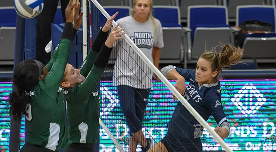 Madilyn McCarty follows through on an attack attempt at the net sending the ball over two USC Upstate blockers.