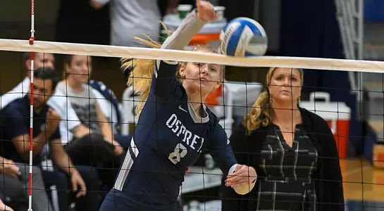 Grace Peterson leaps at the net and sends an attack attempt into the top of the net.