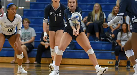 Callie Workman gets underneath a dig attempt as two UNF players look on in the background.