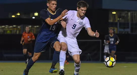 Mikey Connell dribbling ball near FIU defender