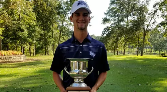 Philip Knowles poses with championship trophy at the Shoal Creek Intercollegiate
