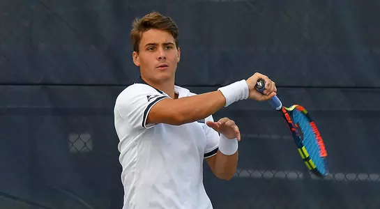 Men's tennis player Dominik Barton returns the ball.