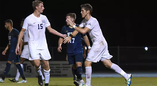 Mikey Connell and Bryson Smith celebrate on the field with high fives.