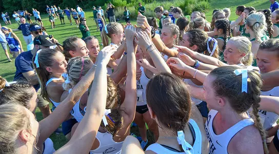 women's cross country team huddle
