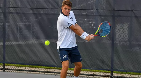Dominik Barton attempts two-handed backhand as he eyes the ball.