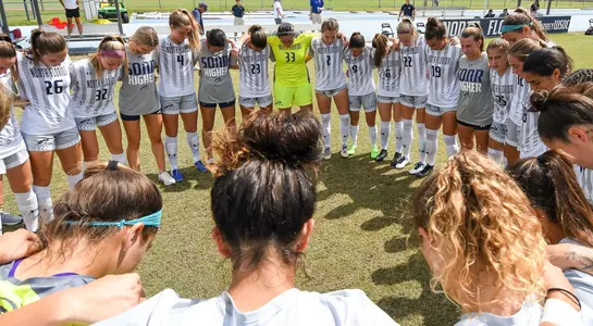 North Florida women's soccer team circled up on field after match
